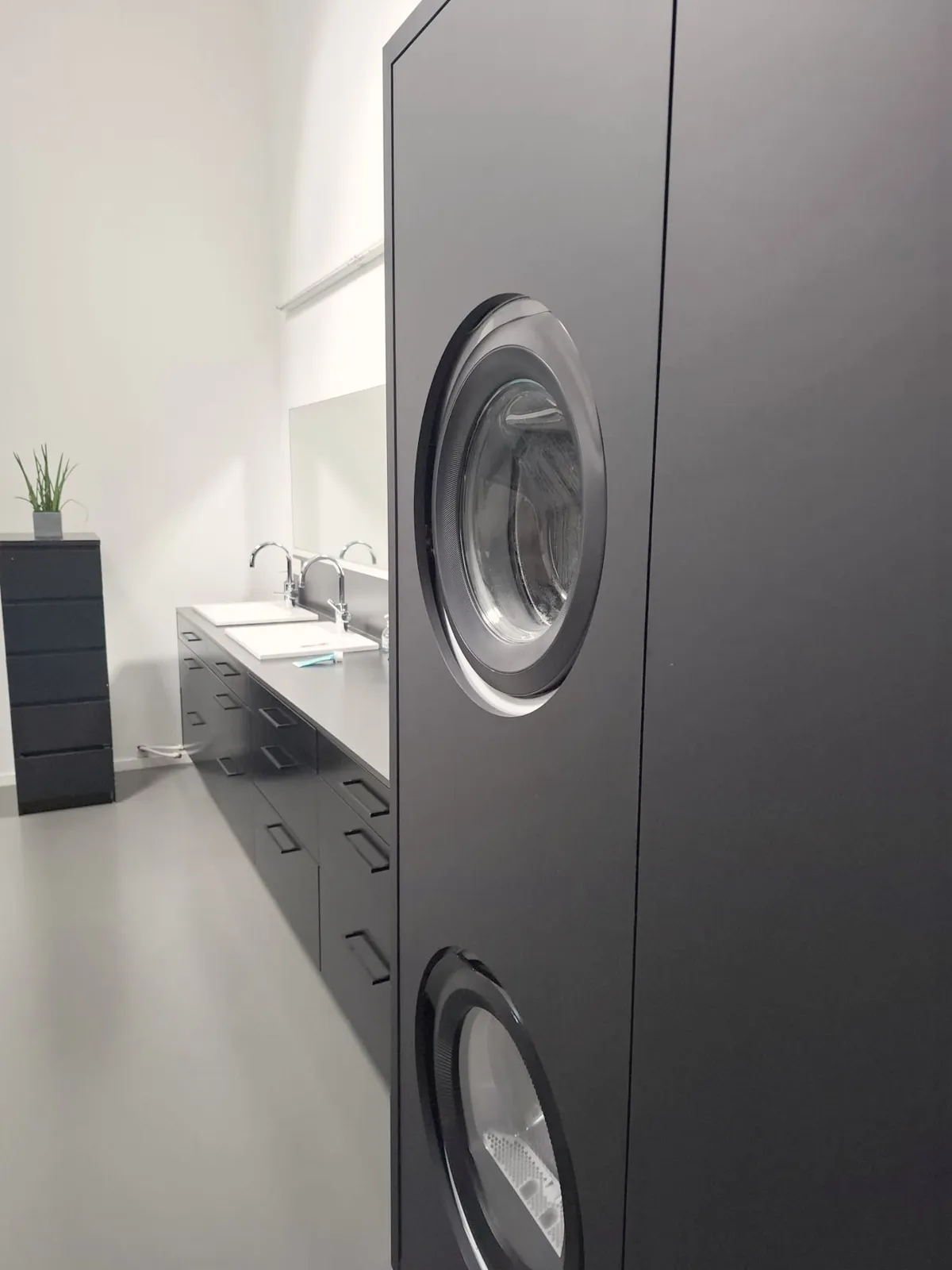 Black cabinet with built-in washer and dryer